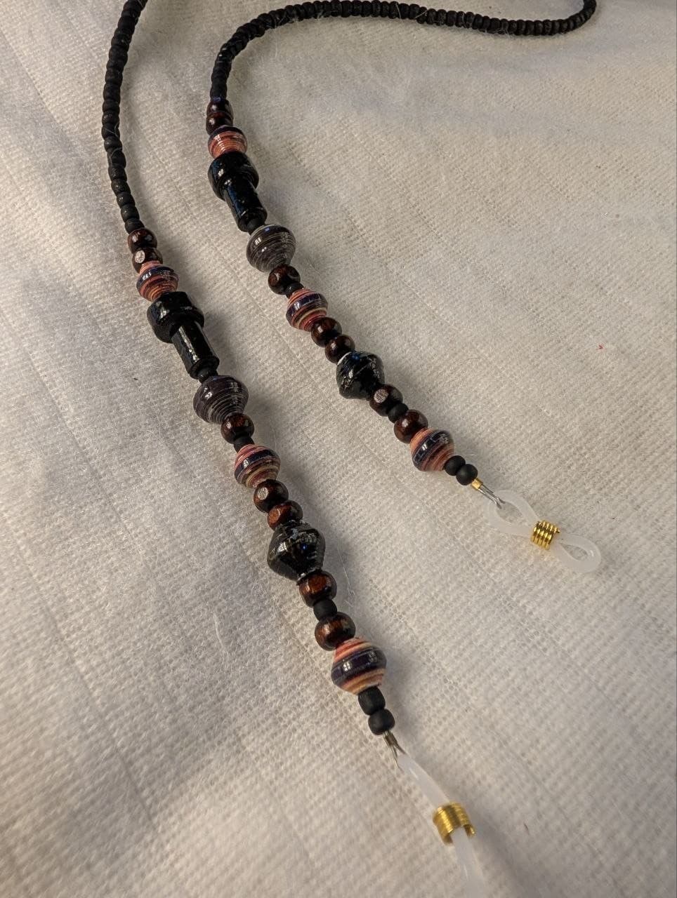 Red rolled paper bead eyeglass holder on a bright green cord with gold-tone lobster clasps view 3