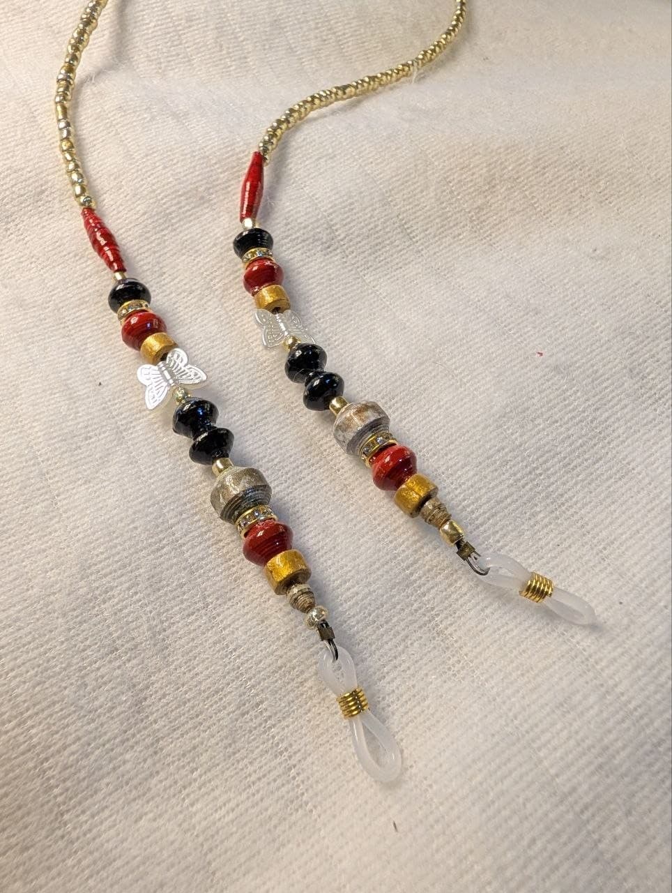 Red rolled paper bead eyeglass holder on a bright green cord with gold-tone lobster clasps view 7