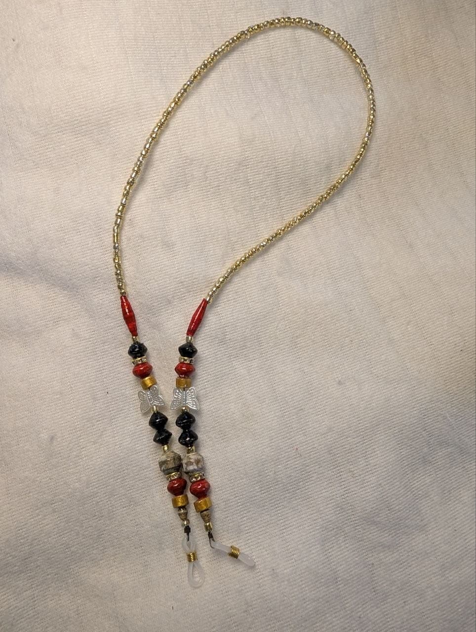 Red rolled paper bead eyeglass holder on a bright green cord with gold-tone lobster clasps view 8