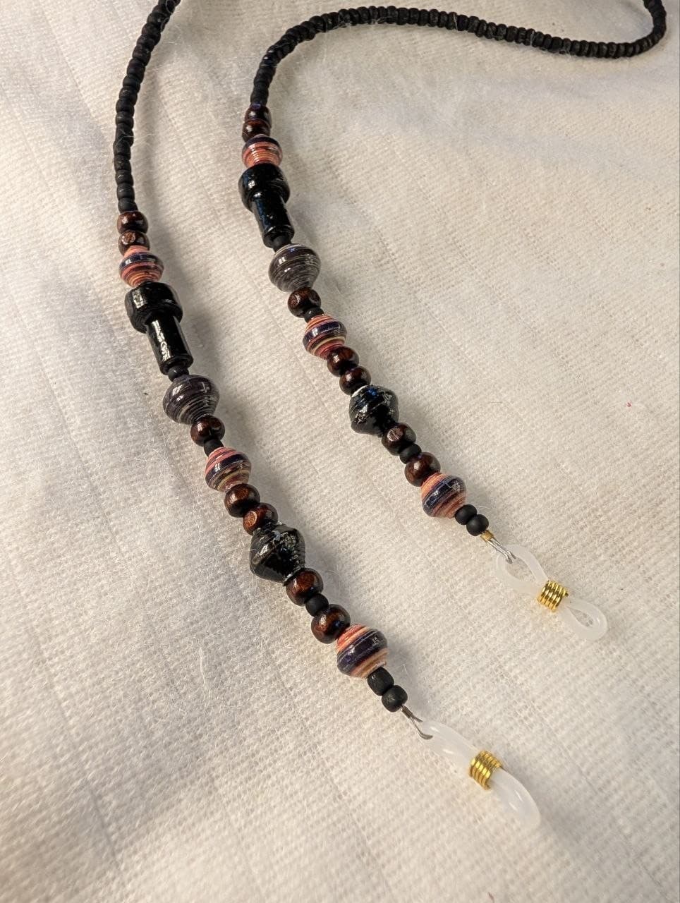 Red rolled paper bead eyeglass holder on a bright green cord with gold-tone lobster clasps view 9