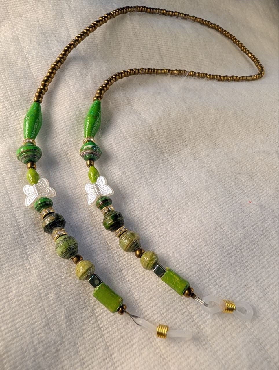 Red rolled paper bead eyeglass holder on a bright green cord with gold-tone lobster clasps view 10